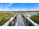 Wooden dock extending over calm water, offering scenic views at 10300 Coral Landings Ct # 91, Placida, FL 33946