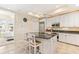 Well-equipped kitchen with white cabinets, granite counters, and island at 10300 Coral Landings Ct # 91, Placida, FL 33946