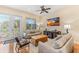 Bright living room featuring comfortable sofas, hardwood floors, and a large TV at 10300 Coral Landings Ct # 91, Placida, FL 33946