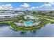 Resort-style pool surrounded by lush landscaping at 10300 Coral Landings Ct # 91, Placida, FL 33946