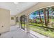 Covered patio with a view of the lush backyard and palm trees at 10300 Coral Landings Ct # 91, Placida, FL 33946