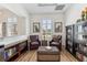Comfortable sitting room with leather chairs, a decorative chest, and well-stocked bookshelves at 10300 Coral Landings Ct # 91, Placida, FL 33946