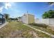 Landscaped backyard with storage sheds at 1740 Faust Dr, Englewood, FL 34224