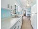 White kitchen cabinets and appliances, light blue walls at 1740 Faust Dr, Englewood, FL 34224