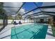 Relaxing pool area with covered patio and lounge chairs at 1740 Faust Dr, Englewood, FL 34224