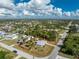 Single story house with gray roof, orange accents, and fenced yard at 18380 Ohara Dr, Port Charlotte, FL 33948