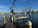 Private boat lift with wooden dock and cover at 1940 Mississippi Ave, Englewood, FL 34224