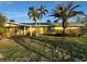 Ranch style home with palm trees and a spacious yard at 1940 Mississippi Ave, Englewood, FL 34224