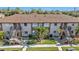 Aerial view of a condo building with two stories, brown roofs, and staircases leading to each unit at 25100 Sandhill Blvd # B-103, Punta Gorda, FL 33983