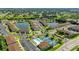 Aerial view of community with pool, pickleball courts, and pond at 25100 Sandhill Blvd # B-103, Punta Gorda, FL 33983