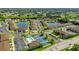 Aerial view of community with pool, pickleball courts, and pond at 25100 Sandhill Blvd # B-103, Punta Gorda, FL 33983