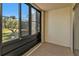 Enclosed patio with view of lush landscape at 25100 Sandhill Blvd # B-103, Punta Gorda, FL 33983
