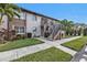 Two-story building with stairs and well-maintained landscaping at 25100 Sandhill Blvd # B-103, Punta Gorda, FL 33983