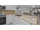 Modern kitchen with white cabinets, granite countertops, and stainless steel appliances at 25100 Sandhill Blvd # B-103, Punta Gorda, FL 33983