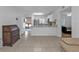 Open kitchen with white cabinets, granite counters, and stainless steel appliances at 25100 Sandhill Blvd # B-103, Punta Gorda, FL 33983