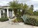 Landscaped front yard with palms and plants at 2761 Rhumba Ter, North Port, FL 34286