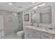 Clean bathroom with a walk-in shower and white cabinets at 2950 N Beach Rd # A315, Englewood, FL 34223