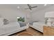 Guest bedroom with two twin beds and a ceiling fan at 2950 N Beach Rd # A315, Englewood, FL 34223