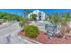 Condo building entrance with a welcoming sign and landscaping at 2950 N Beach Rd # A315, Englewood, FL 34223