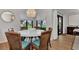 Bright dining area with white table and wicker chairs, overlooking a garden at 2950 N Beach Rd # A315, Englewood, FL 34223