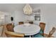 Round dining table with wicker chairs, under a beaded chandelier at 2950 N Beach Rd # A315, Englewood, FL 34223