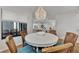 Bright dining area with round table and chairs, offering view to living room at 2950 N Beach Rd # A315, Englewood, FL 34223