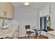 Cozy kitchen nook with glass table and wicker chairs at 2950 N Beach Rd # A315, Englewood, FL 34223
