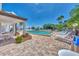 Community pool with lounge chairs and patio seating at 2950 N Beach Rd # A315, Englewood, FL 34223