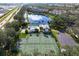 Community pool, tennis courts, and parking area at 412 Sunset Lake Blvd # 206, Venice, FL 34292