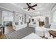 Open and airy Gathering room with hardwood floors, white sofas, and a view of the kitchen at 421 Baynard Dr, Venice, FL 34285