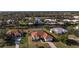 An aerial view of a Florida waterfront home with tile roof, pool, and lush landscaping at 4658 Arlington Dr, Placida, FL 33946