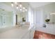 Bright bathroom with dual vanities, a glass-enclosed shower, and tiled flooring at 4658 Arlington Dr, Placida, FL 33946