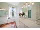 Bright bathroom with dual vanities, a glass-enclosed shower, and tiled flooring at 4658 Arlington Dr, Placida, FL 33946