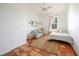 Cozy bedroom with a ceiling fan, bed, small couch, and tiled flooring at 4658 Arlington Dr, Placida, FL 33946