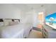 Bright bedroom featuring a king-size bed, large TV, and ensuite laundry at 4658 Arlington Dr, Placida, FL 33946