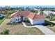 Exterior elevation of a single-story home with tile roof, landscaped yard, and attached garage at 4658 Arlington Dr, Placida, FL 33946