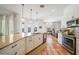 Bright kitchen with white cabinets, granite countertops, stainless steel appliances, and tile floors at 4658 Arlington Dr, Placida, FL 33946