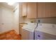 Laundry room with washer, dryer, and ample cabinet space for storage at 4658 Arlington Dr, Placida, FL 33946