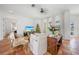 Living room with white couch, wicker chairs, Christmas tree, and large windows overlooking the water at 4658 Arlington Dr, Placida, FL 33946