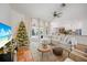 Living room with white sectional sofa, Christmas tree, and view to the pool and backyard at 4658 Arlington Dr, Placida, FL 33946