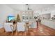 Living room with white furniture, Christmas tree, and open view to the kitchen and pool area at 4658 Arlington Dr, Placida, FL 33946