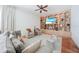 Comfortable living room with a ceiling fan, built-in entertainment center, and stylish furniture at 4658 Arlington Dr, Placida, FL 33946