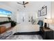 Inviting main bedroom with a ceiling fan, stylish decor, and access to the ensuite bathroom at 4658 Arlington Dr, Placida, FL 33946