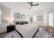 Inviting main bedroom with a ceiling fan, stylish decor, and access to the ensuite bathroom at 4658 Arlington Dr, Placida, FL 33946