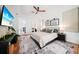 Inviting main bedroom with a ceiling fan, stylish decor, and access to the ensuite bathroom at 4658 Arlington Dr, Placida, FL 33946
