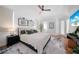 Inviting main bedroom with a ceiling fan, stylish decor, and access to the ensuite bathroom at 4658 Arlington Dr, Placida, FL 33946