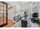 Well-lit home office with large windows, a functional workspace, and access to the dining area at 4658 Arlington Dr, Placida, FL 33946