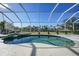 Screened-in pool with a spa, ample patio space, and lush landscaping at 4658 Arlington Dr, Placida, FL 33946