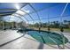 Inviting pool with a spa, screened enclosure, and surrounding landscaping at 4658 Arlington Dr, Placida, FL 33946
