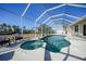 Inviting pool and spa under a screened enclosure at 4658 Arlington Dr, Placida, FL 33946